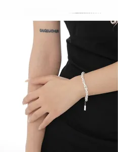 Detailed view of S925 sterling silver knotted chain bracelet with a rectangular tag