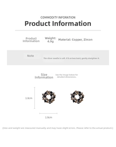 Detail view of circular hollow earrings with dark zircons and 1.8cm diameter
