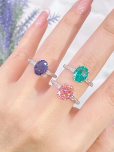 Detailed view of three luxury S925 silver rings with large emerald-cut colorful gemstones