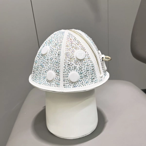 Close-up of mushroom-shaped white handbag with sparkling rainbow rhinestones and gold zipper