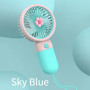 Macro view of portable mini fan in sky blue and pink colors with a soft lanyard