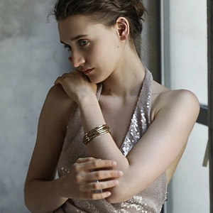 Elegant 18K gold-plated stainless steel bangle set with rhinestones on model's wrist