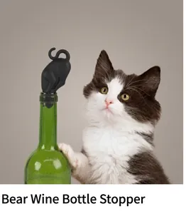 Close-up of a black silicone bear-shaped wine stopper on a green bottle neck