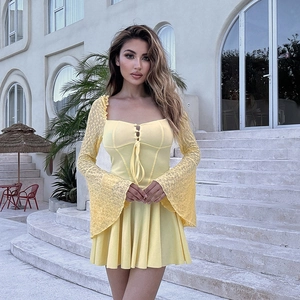 Detail of elegant yellow lace flared sleeves and tie-up front on a slim bodycon dress