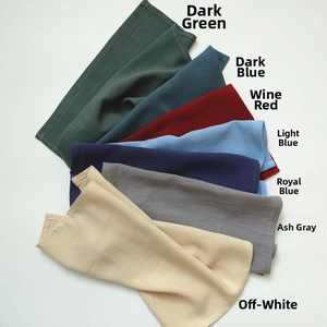 Close-up of linen waffle napkins in dark green, blue, burgundy, grey and cream colors