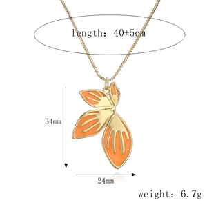Gold leaf pendant necklace with orange enamel detailing and size measurements