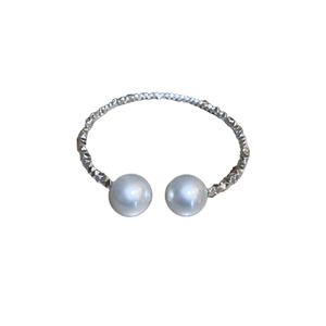 Elegant silver open bangle featuring textured metal finish and large white pearls