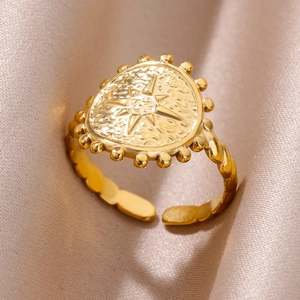Macro shot of 18k gold-plated starburst relief ring on champagne satin background