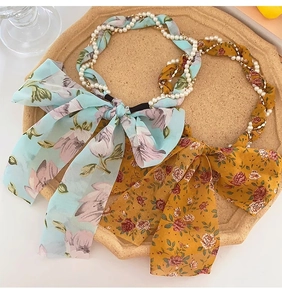 Floral print headbands with pearls and chain details in light blue and yellow