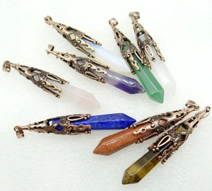 Detailed view of hexagonal natural crystal pendants with vintage bronze floral caps