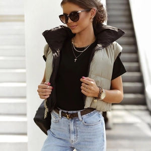 Detailed view of women's short puffer vest with stand collar and front zipper closure