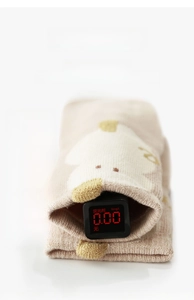 Close-up of beige baby sock showing 0.00 fluorescence reading for safety
