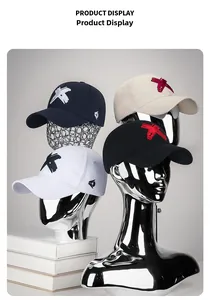 Detailed close-up of 3D embroidered X logo on cotton baseball caps in various colors