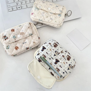 Detail of quilted mini coin purses with cute cartoon prints and snap closure pockets