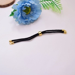 Detail of black Milan cord bracelet with 18K gold-plated sliding clasp and metal ends