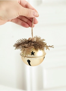 Golden Christmas bell pendant with pine needles and pinecones hanging by jute rope