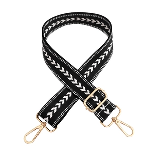Adjustable black nylon shoulder strap with white arrow pattern and gold metal hooks