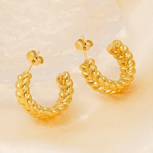 Chic gold-plated stainless steel twisted C-hoop earrings on a silk textured background