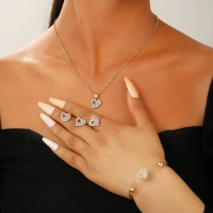 Detailed view of gold plated heart jewelry set with necklace earrings ring and bracelet