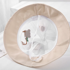 Detail view of the breathable mesh lining and adjustable windproof cord inside the sun hat