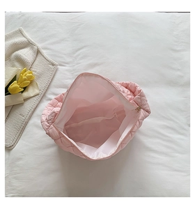 Interior view showing the large capacity and smooth zipper of the pink quilted tote bag
