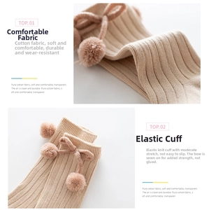 Detail view of cotton baby socks with rib texture, soft pom poms and elegant bows