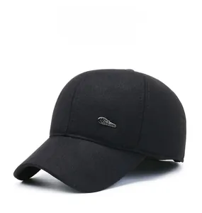 Close-up of winter wool baseball cap featuring a silver Fashion metal emblem on black fabric