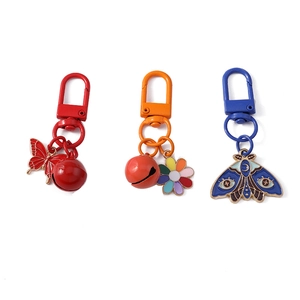Chic butterfly and bell flower keychains with vibrant enamel charms for backpacks