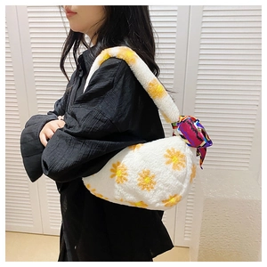 Detail view of white plush daisy shoulder bag with decorative colorful silk scarf handle
