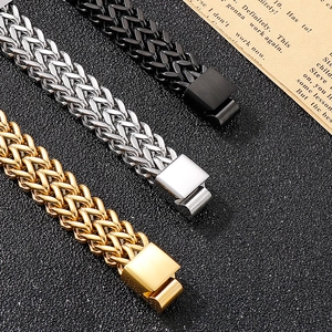 Close-up of thick franco link bracelets in gold, silver and black with square clasps