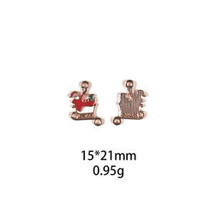 Detailed macro view of 15x21mm Santa Claus sleigh alloy charm in red and gold enamel