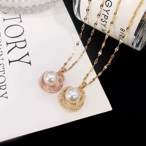 Elegant pearl pendant necklace in gold and rose gold finishes with micro-pave crystals