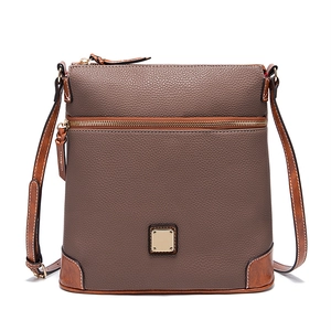 Detail of coffee brown crossbody bag showing lychee grain leather and gold hardware