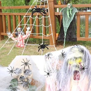 Glow-in-the-dark Halloween spider web with plush giant spiders and skeleton props