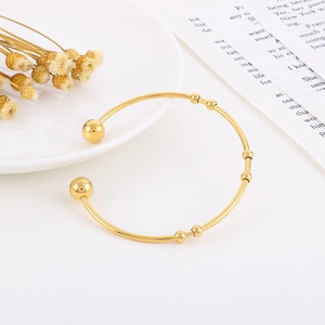Minimalist gold stainless steel open cuff bracelet with polished bead accents for women