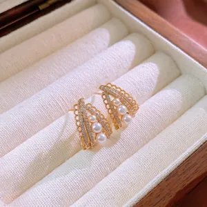 Elegant gold fan-shaped geometric earrings with white pearls and sparkling cubic zirconia