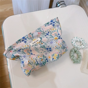 Detailed view of large capacity floral cotton makeup bag with simple wish label and zip