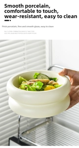 Close-up of cream ceramic bubble bowl with fresh salad showing texture and capacity