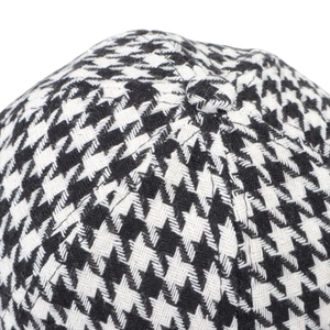 Macro shot of houndstooth baseball cap texture with detailed stitching and top button
