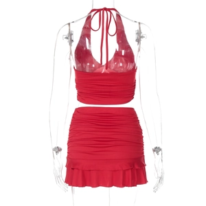 Back view of red halter neck crop top and ruffled mini skirt set on mannequin