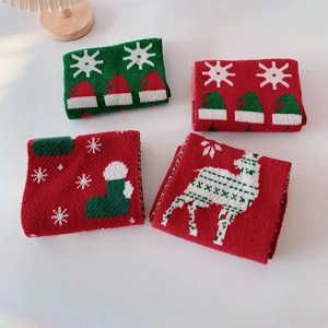 Christmas themed red and green knitted scarves with reindeer and snowflake patterns