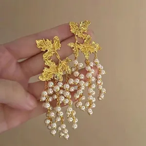 Vintage golden leaf earrings with multi-strand pearl tassels in a boho statement design