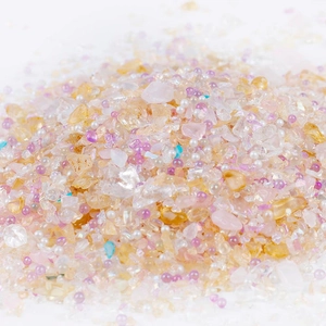 Macro shot of 2-8mm irregular macaron crushed glass and small pearls for DIY nail art