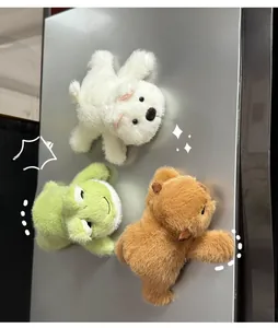 Three plush capybara and animal magnets attached to a metal surface in a close-up detail