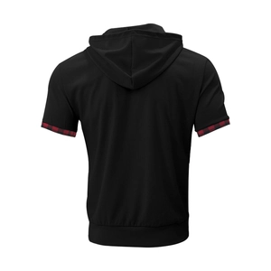Detail of men's black waffle hoodie top showing red checkered patchwork on sleeve cuffs