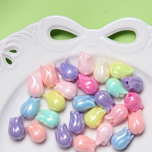 Close-up of pastel tulip beads with pearlescent finish for DIY jewelry crafting