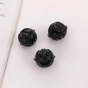Three glossy black Jack-o'-lantern pumpkin bells for Halloween crafting and decoration
