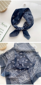 Macro detail of navy blue paisley cotton scarf showing texture and hem stitching