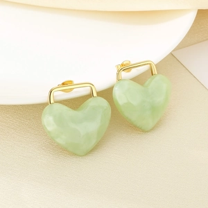 Detailed macro view of 18K gold plated heart earrings with light green marble resin charms