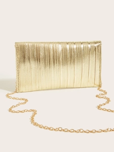 Detailed view of gold pleated evening clutch bag with metallic texture and chain